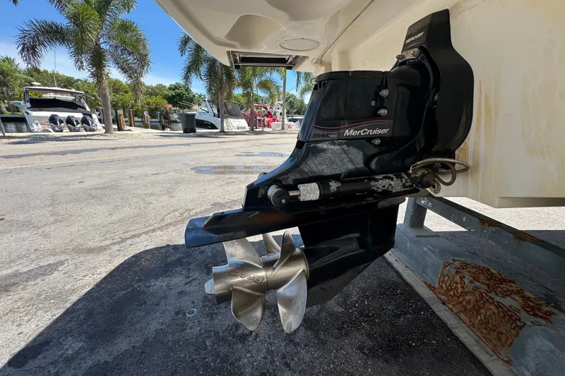 Slide: The Image of 2018 Sea Ray Sundancer 260 with MerCruiser engine, docked near palm trees. - 65
