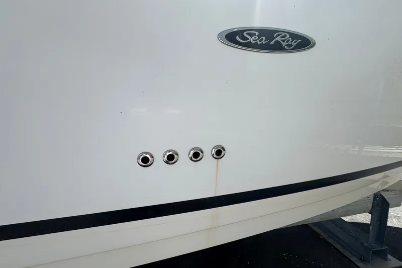 Slide: The Image of 2018 Sea Ray Sundancer 260 boat hull with logo and vent details. - 11