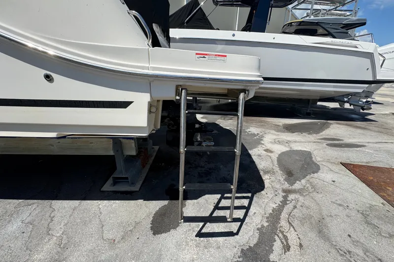 Slide: The Image of 2018 Sea Ray Sundancer 260 boat with extended swim platform and ladder. - 15