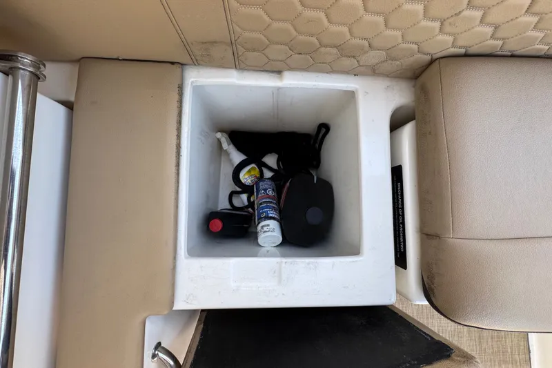 Slide: The Image of Storage compartment on 2018 Sea Ray Sundancer 260 boat with various items inside. - 33