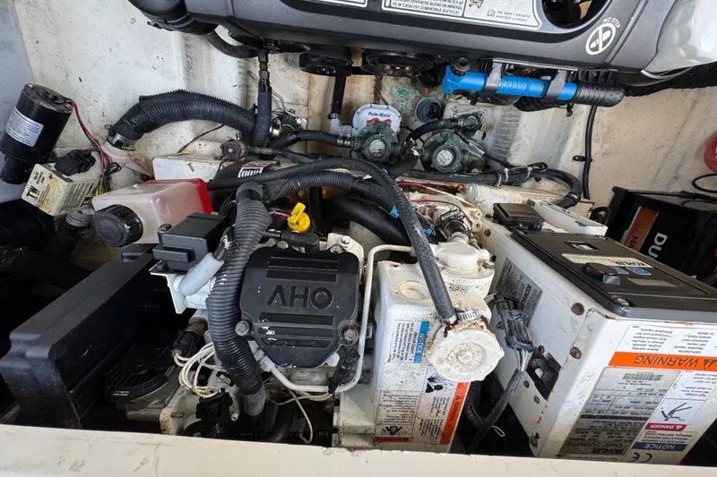 Slide: The Image of Engine compartment of a 2018 Sea Ray Sundancer 260 boat, showcasing mechanical components. - 71