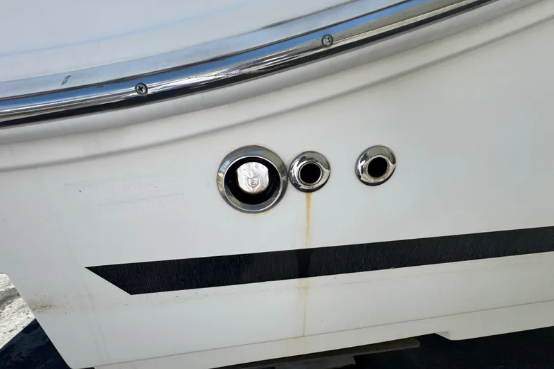 Slide: The Image of 2018 Sea Ray Sundancer 260 boat hull with chrome fittings and drainage outlets. - 86