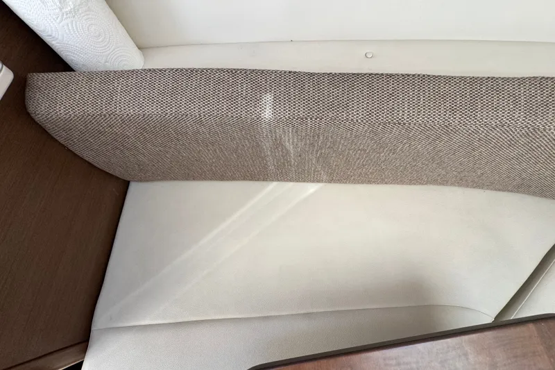 Slide: The Image of Interior seating of 2018 Sea Ray Sundancer 260 boat, featuring beige upholstery and wooden accents. - 61