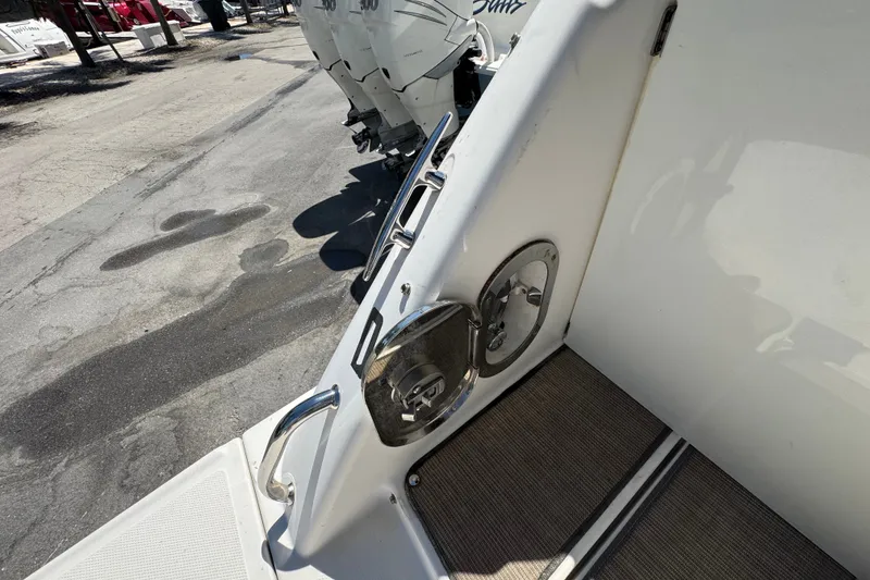 Slide: The Image of 2018 Sea Ray Sundancer 260 boat deck with stainless steel fixtures and outboard motors. - 82