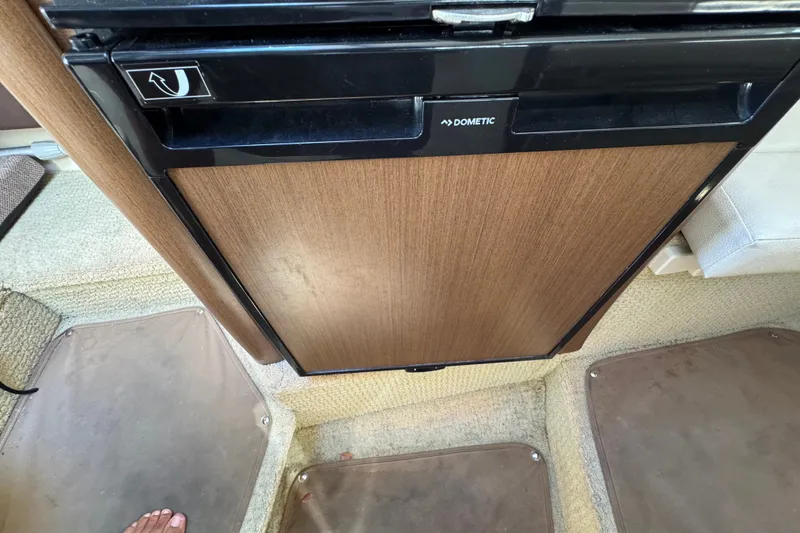 Slide: The Image of Interior of a 2018 Sea Ray Sundancer 260 featuring a Dometic fridge. - 37