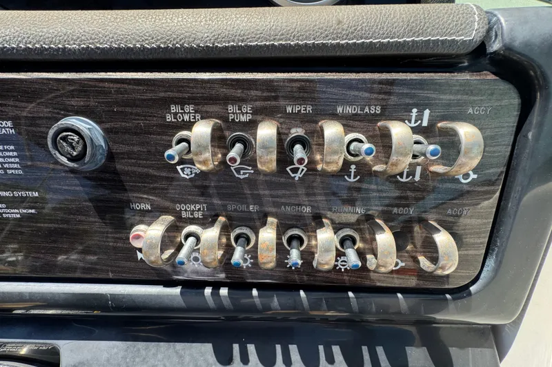 Slide: The Image of Control panel of a 2018 Sea Ray Sundancer 260 boat with various switches. - 55