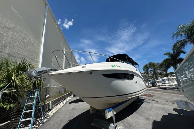 Slide: The Image of 2018 Sea Ray Sundancer 260 boat on dry dock under clear blue sky. - 3