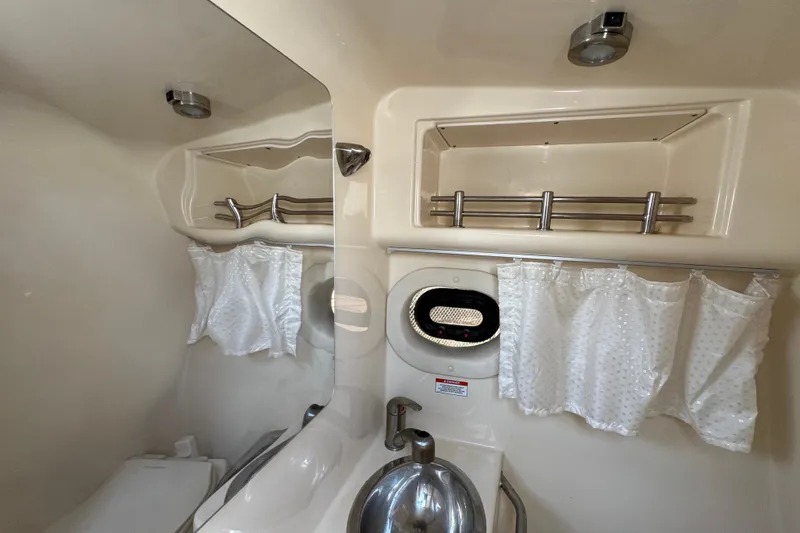 Slide: The Image of Interior of 2018 Sea Ray Sundancer 260 boat bathroom with sink and storage shelves. - 49