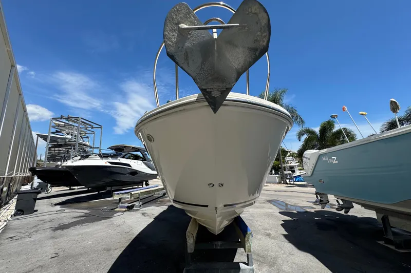 Slide: The Image of 2018 Sea Ray Sundancer 260 boat on trailer under clear blue sky. - 4