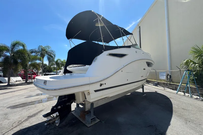 Slide: The Image of 2018 Sea Ray Sundancer 260 boat on display, featuring a sleek design and canopy. - 1