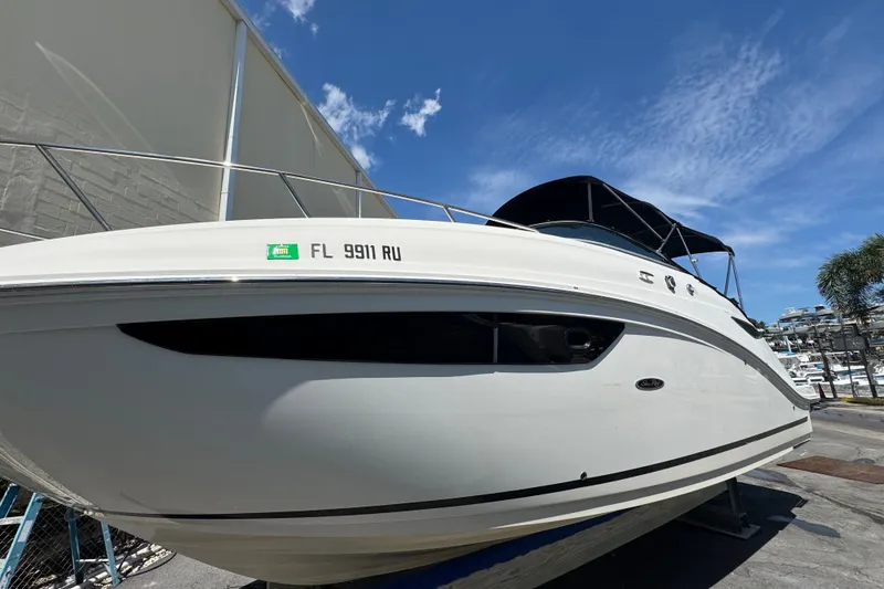 Slide: The Image of 2018 Sea Ray Sundancer 260 boat docked under clear blue sky. - 6