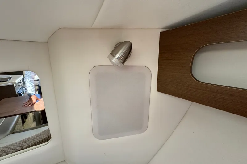 Slide: The Image of Interior cabin of 2018 Sea Ray Sundancer 260 with modern light fixture and wood accents. - 42