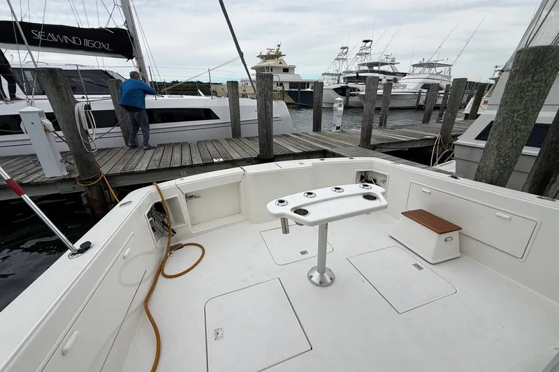 Slide: The Image of 2003 Ocean Yachts 43 Super Sport docked, featuring spacious deck and fishing rod holders. - 8