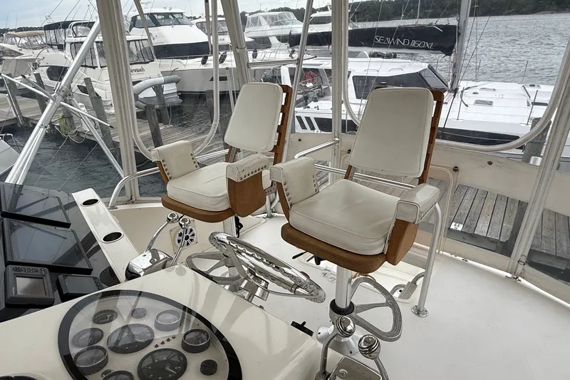 Slide: The Image of 2003 Ocean Yachts 43 Super Sport helm with dual captain chairs and control panel. - 12
