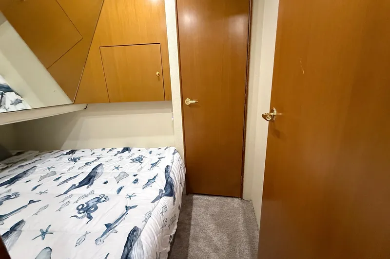 Slide: The Image of Cozy cabin interior of 2003 Ocean Yachts 43 Super Sport with marine-themed bedding. - 19