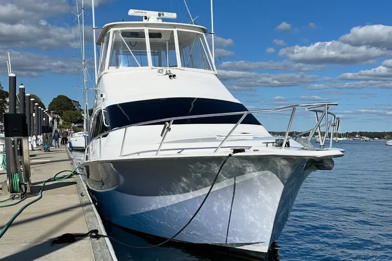 Slide: The Image of 2003 Ocean Yachts 43 Super Sport docked at marina under blue sky. - 1