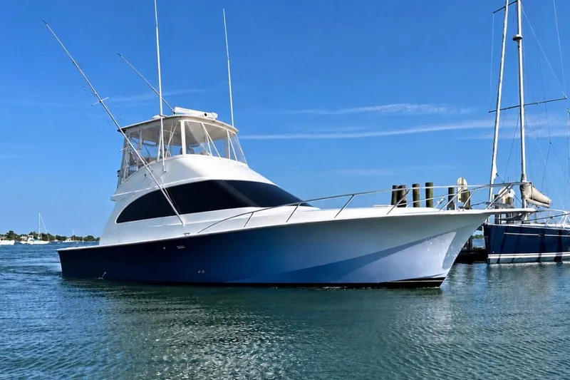 The Image of 2003 Ocean Yachts 43 Super Sport boat on calm water under clear blue sky. - 0