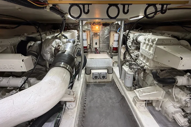 Slide: The Image of Engine room of 2003 Ocean Yachts 43 Super Sport, featuring dual Yanmar engines. - 27
