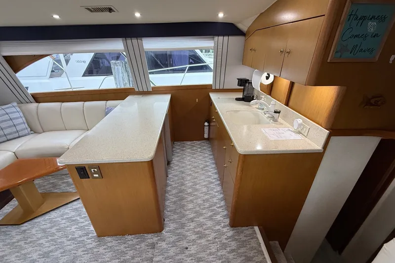 Slide: The Image of Interior of 2003 Ocean Yachts 43 Super Sport with kitchen and seating area. - 18
