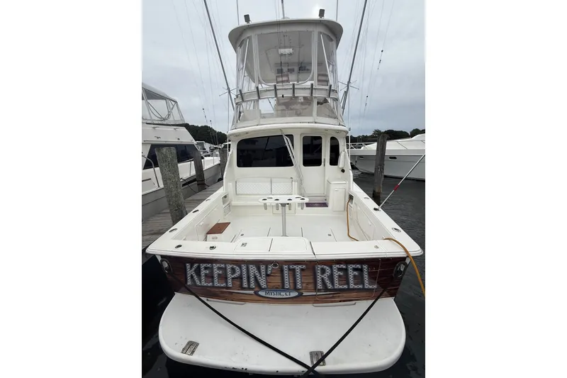 Slide: The Image of 2003 Ocean Yachts 43 Super Sport docked, rear view with "Keepin' It Reel" nameplate. - 2