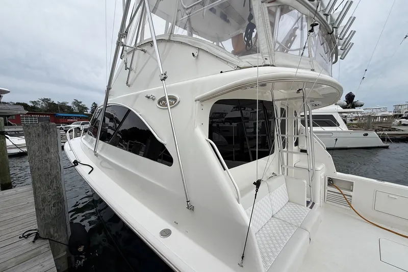 Slide: The Image of 2003 Ocean Yachts 43 Super Sport docked at marina, showcasing sleek design and spacious deck. - 3