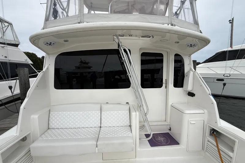 Slide: The Image of 2003 Ocean Yachts 43 Super Sport boat interior with seating and ladder. - 7