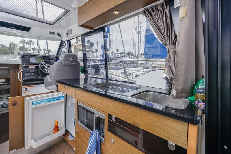 Slide: The Image of Interior of 2020 Jeanneau NC 1095 boat with kitchenette and helm station. - 24