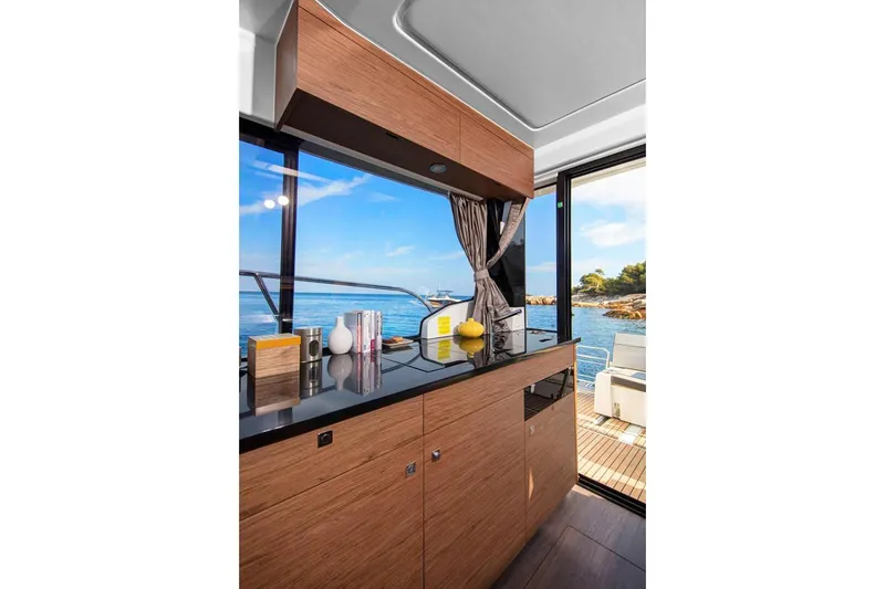 Slide: The Image of Manufacturer Provided Image: Modern kitchen area on 2020 Jeanneau NC 1095 boat with ocean view. - 16