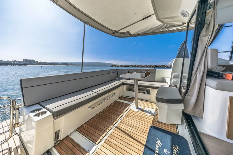 Slide: The Image of 2020 Jeanneau NC 1095 boat deck with seating, table, and ocean view. - 14