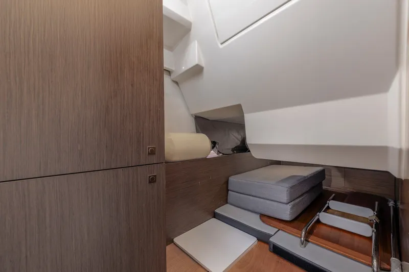 Slide: The Image of Interior cabin of 2020 Jeanneau NC 1095 boat, featuring wooden cabinetry and seating area. - 28