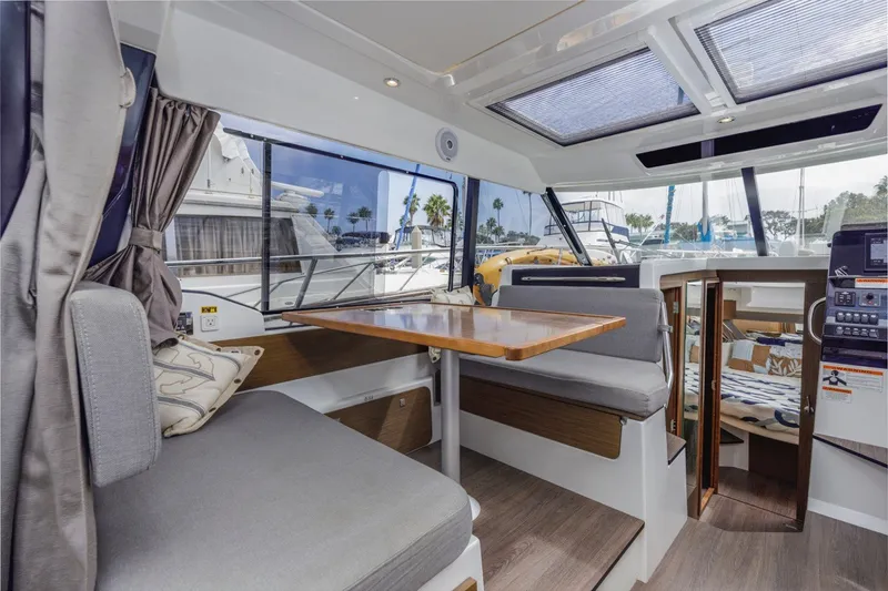 Slide: The Image of Interior of 2020 Jeanneau NC 1095 boat with seating and dining area. - 22
