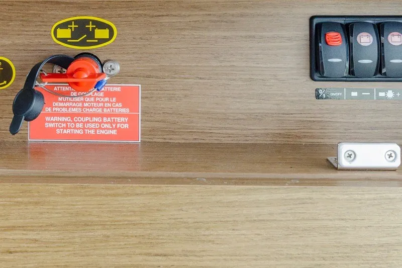 Slide: The Image of Battery switch panel on 2020 Jeanneau NC 1095 boat with warning label. - 36