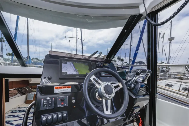 Slide: The Image of Helm of 2020 Jeanneau NC 1095 boat with navigation display and controls. - 25
