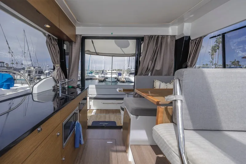 Slide: The Image of Interior of 2020 Jeanneau NC 1095 yacht with modern kitchen and seating area. - 35