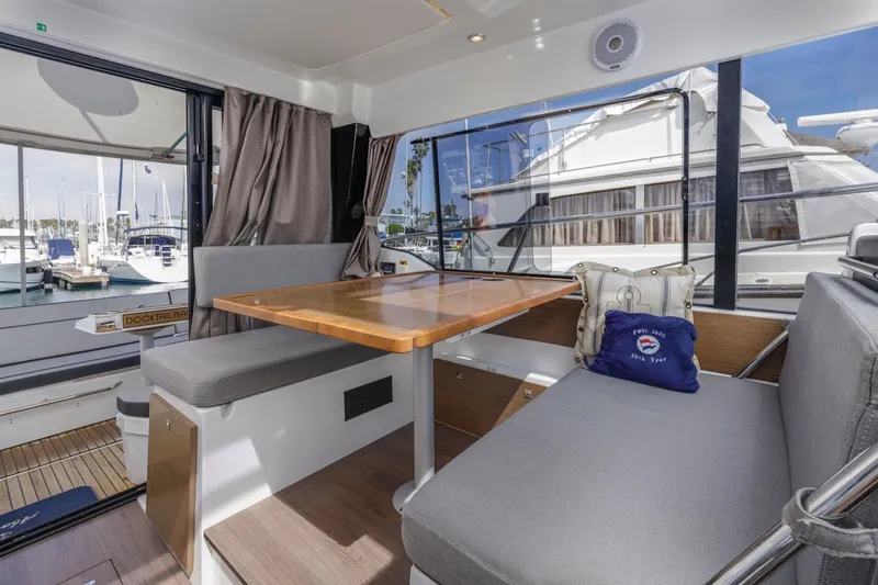 Slide: The Image of Interior of 2020 Jeanneau NC 1095 yacht with dining area and marina view. - 33