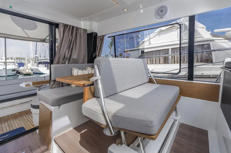 Slide: The Image of Interior of 2020 Jeanneau NC 1095 yacht with seating and marina view. - 34