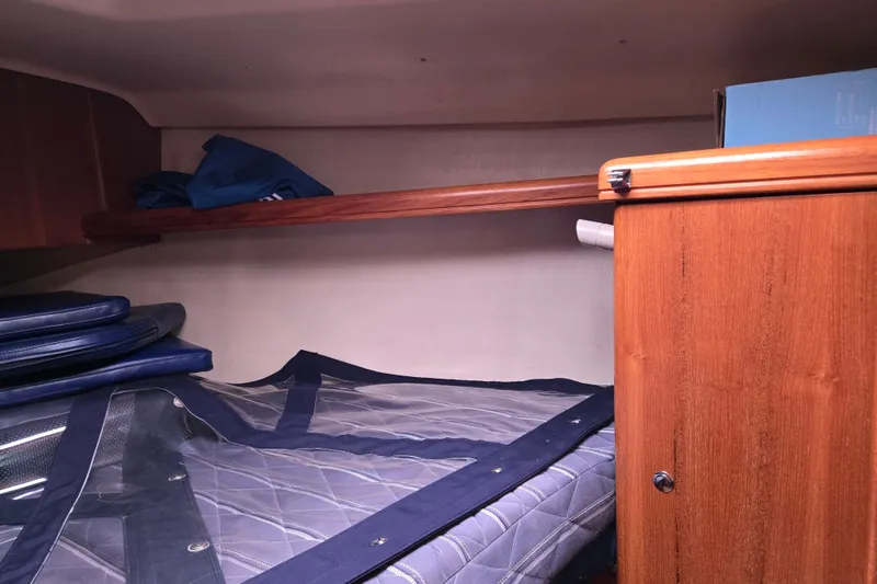 Slide: The Image of Interior cabin of a 2006 Hunter 36 sailboat with wooden storage and bedding. - 16