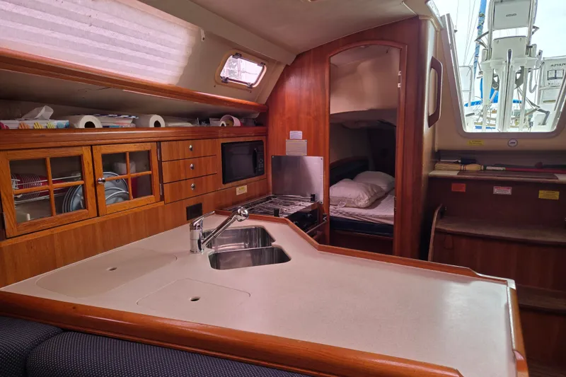 Slide: The Image of Interior of 2006 Hunter 36 sailboat with kitchen and cozy sleeping area. - 23