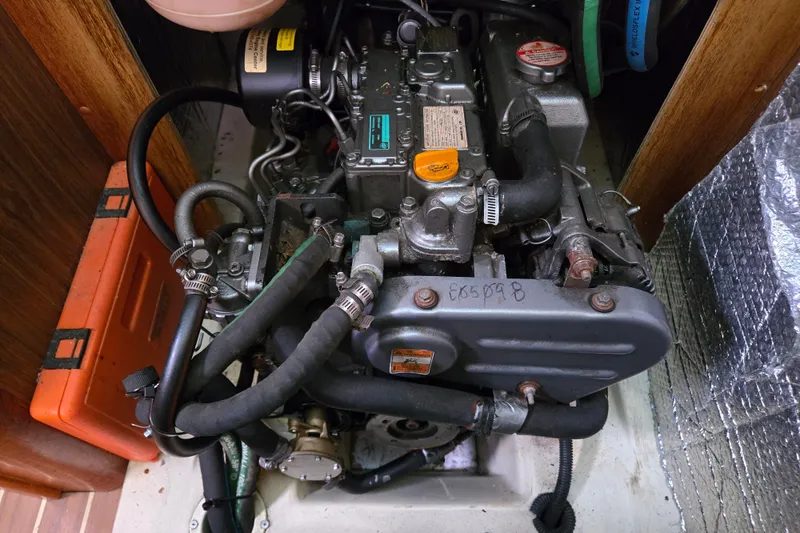 Slide: The Image of Engine compartment of a 2006 Hunter 36 sailboat, showcasing mechanical components and hoses. - 39