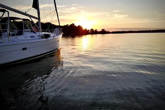 Slide: The Image of Sailboat Hunter 36 (2006) on serene water at sunset. - 48