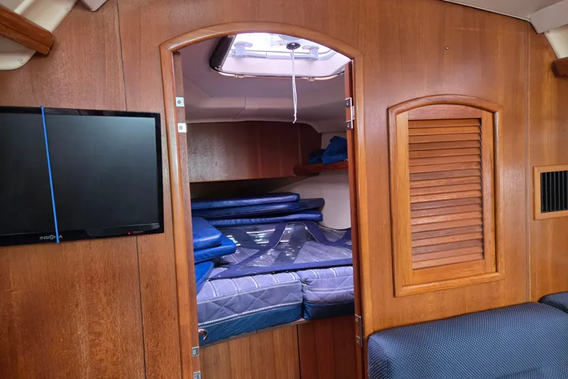 Slide: The Image of Interior of 2006 Hunter 36 sailboat with cozy cabin and mounted TV. - 14