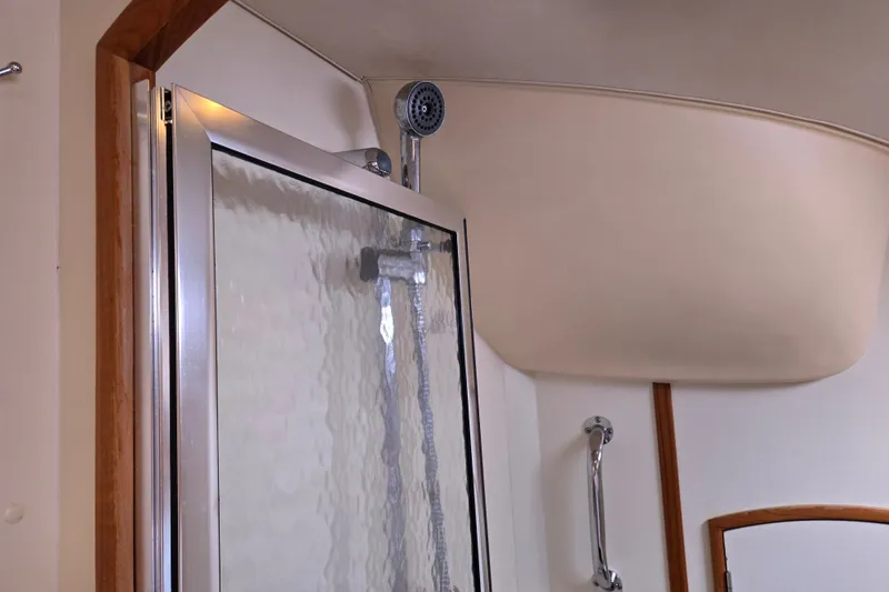 Slide: The Image of Shower area inside a 2006 Hunter 36 yacht, featuring a glass door and chrome fixtures. - 35
