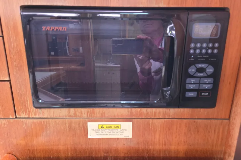 Slide: The Image of Tappan microwave in a 2006 Hunter 36 yacht kitchen, with wood paneling and control panel. - 29
