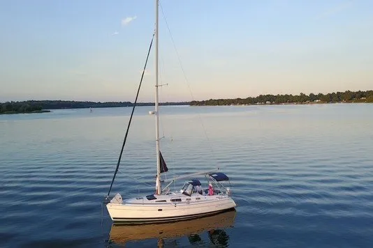The Image of 2006 Hunter 36 sailboat on calm lake waters at sunset. - 0