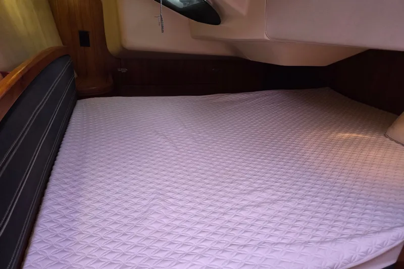 Slide: The Image of Cozy cabin bed in a 2006 Hunter 36 sailboat, featuring a quilted mattress. - 33