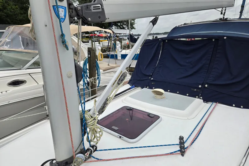 Slide: The Image of Sailboat deck of 2006 Hunter 36 with rigging and blue canvas cover. - 8
