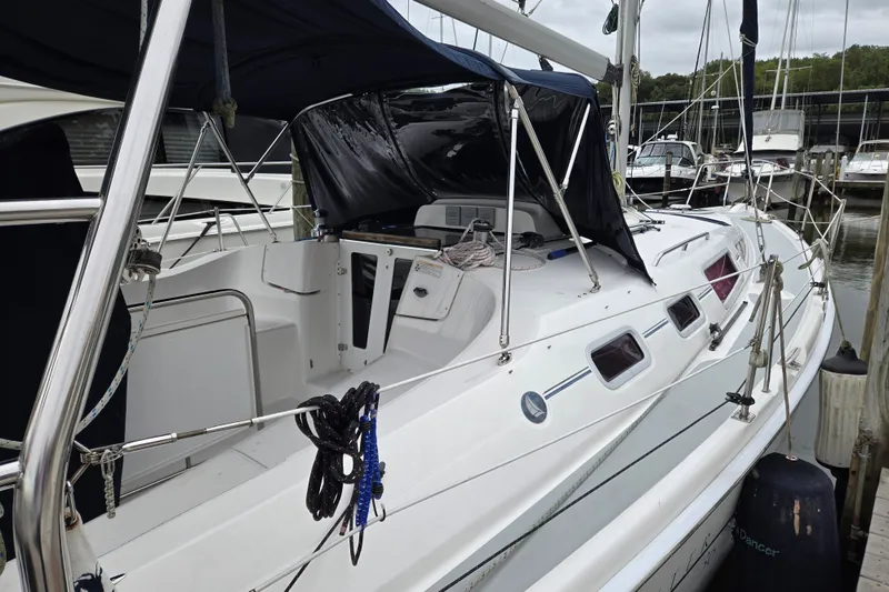 Slide: The Image of 2006 Hunter 36 sailboat docked, featuring a spacious cockpit and sleek design. - 2