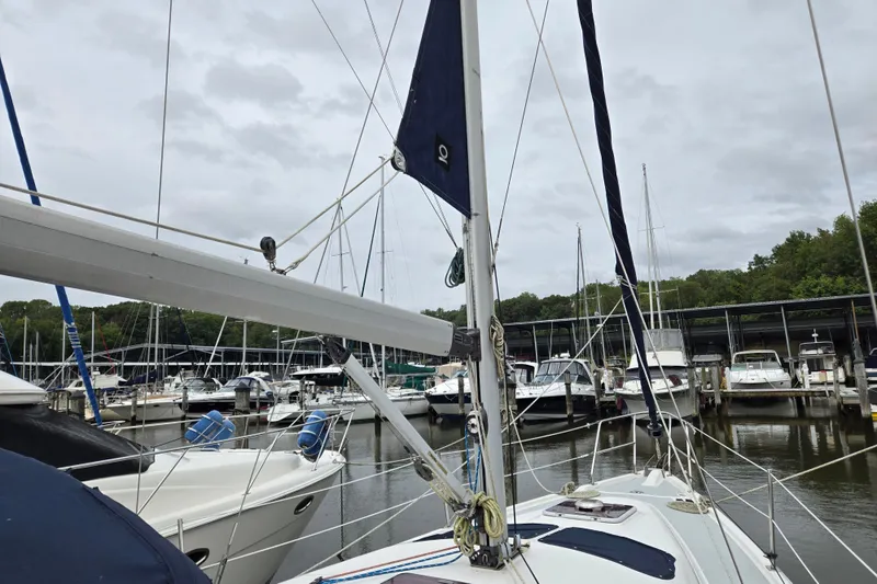 Slide: The Image of Sailboats docked at a marina, featuring a 2006 Hunter 36 sailboat. - 45