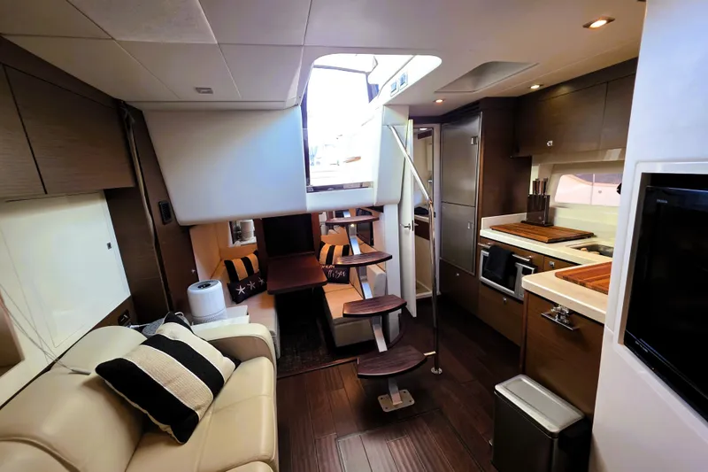 Slide: The Image of Luxurious interior of 2012 Sea Ray 410 Sundancer yacht with modern kitchen and seating area. - 33