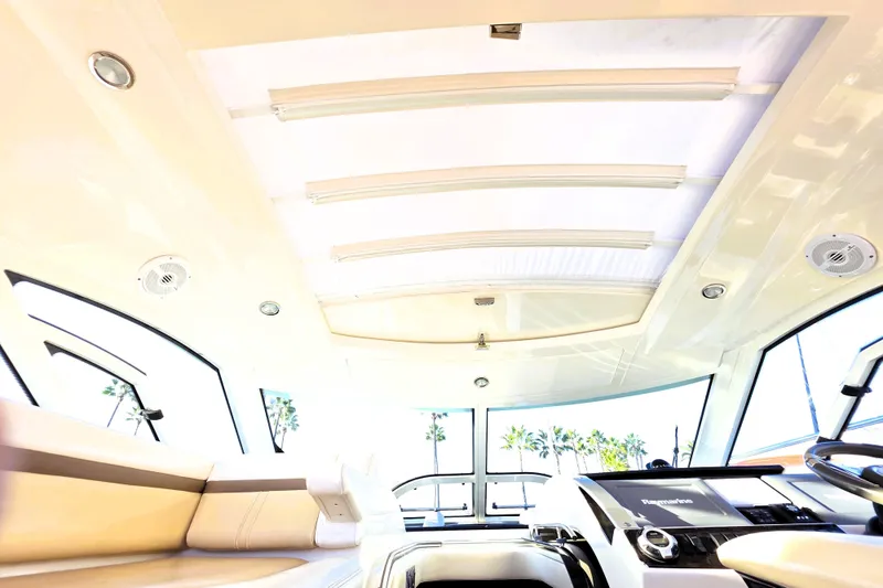 Slide: The Image of Interior view of 2012 Sea Ray 410 Sundancer yacht with modern helm and seating. - 36